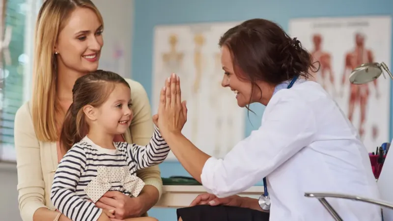 dr giving high five to child patient